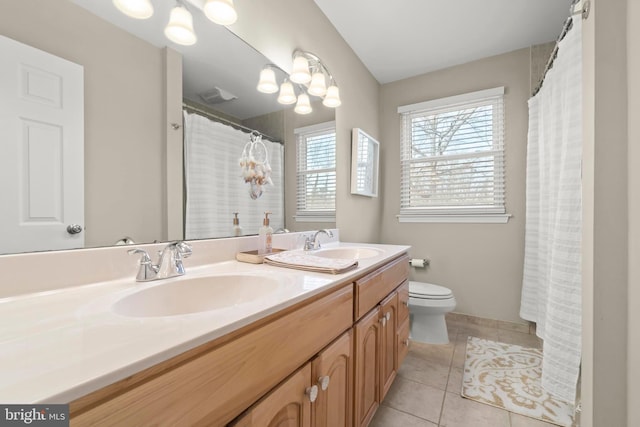 bathroom featuring tile patterned flooring, vanity, and toilet