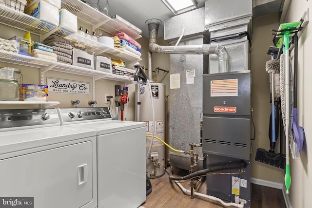 laundry room featuring washer and dryer, water heater, and light hardwood / wood-style floors