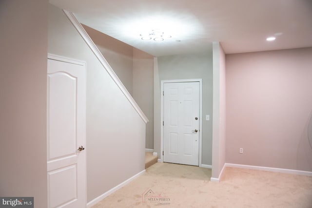 view of carpeted entrance foyer