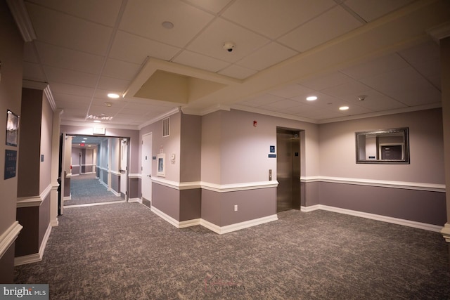interior space featuring ornamental molding, elevator, carpet, and a paneled ceiling
