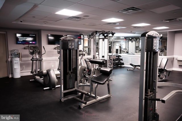 gym featuring a paneled ceiling and visible vents