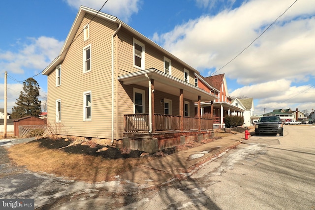 view of side of home with a porch