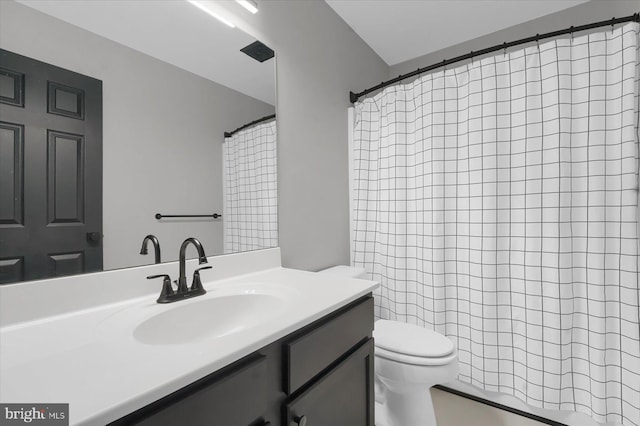 bathroom with toilet, vanity, and a shower with shower curtain