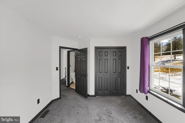 unfurnished bedroom featuring a closet and carpet floors