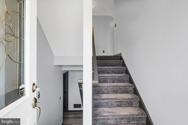 staircase featuring hardwood / wood-style floors