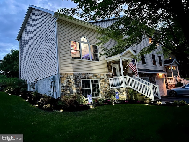 view of front of home with a garage and a front lawn