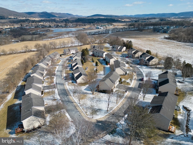 snowy aerial view featuring a mountain view