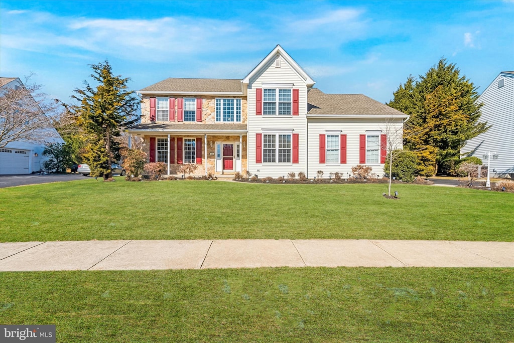 traditional-style home with a porch and a front lawn