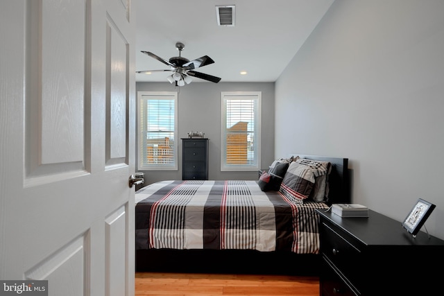 bedroom with recessed lighting, visible vents, ceiling fan, and light wood finished floors