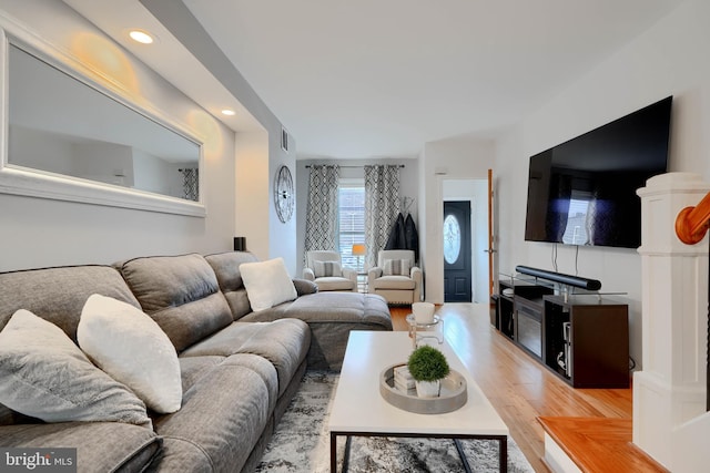 living room featuring recessed lighting, visible vents, and wood finished floors