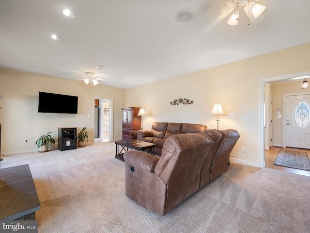 living area with recessed lighting, baseboards, a ceiling fan, and light colored carpet