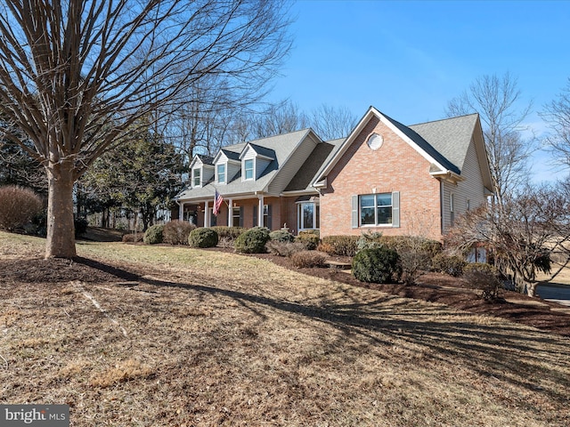 view of home's exterior featuring brick siding and a lawn