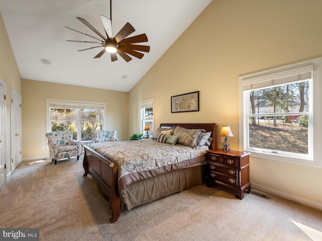 bedroom featuring carpet floors, high vaulted ceiling, baseboards, and visible vents