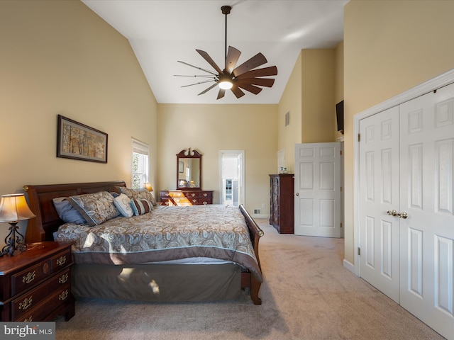 bedroom with light carpet, baseboards, a ceiling fan, high vaulted ceiling, and a closet