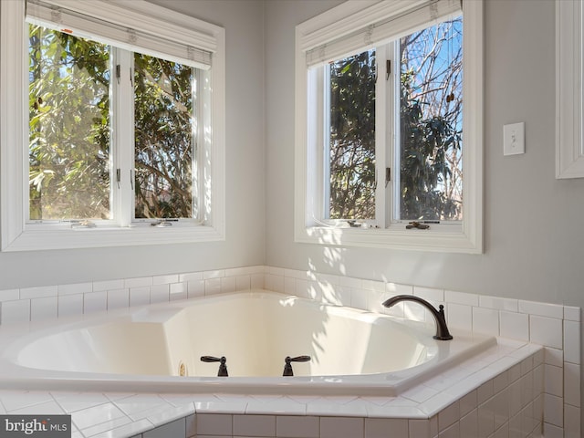 bathroom with a relaxing tiled tub