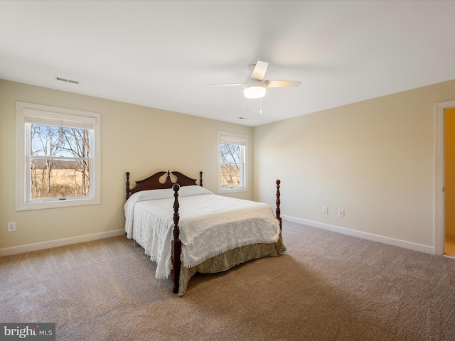 bedroom with carpet, visible vents, ceiling fan, and baseboards