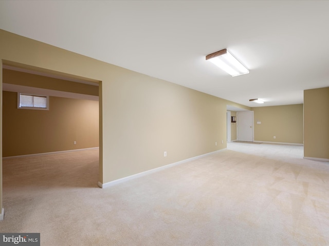 finished basement with light carpet and baseboards