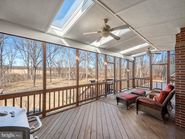 sunroom featuring a skylight, plenty of natural light, and a ceiling fan