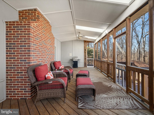 sunroom with ceiling fan and vaulted ceiling