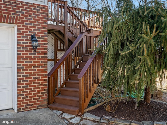 exterior space featuring a garage and brick siding