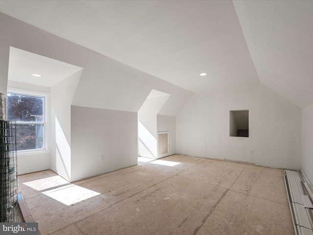 additional living space featuring lofted ceiling