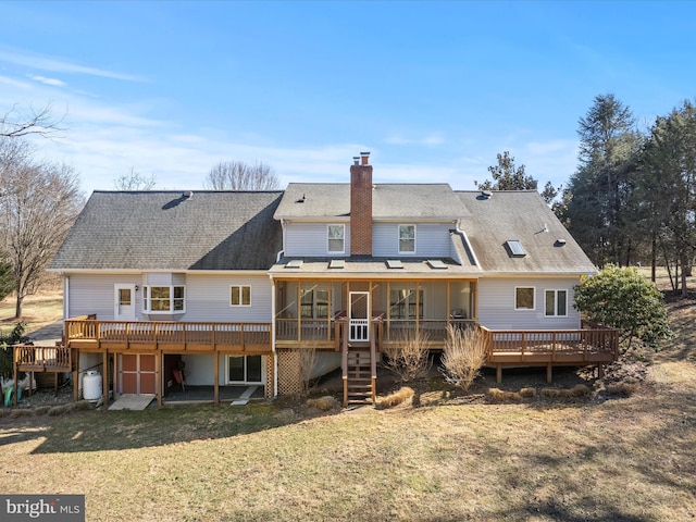 rear view of property with stairs, a yard, a deck, and a chimney