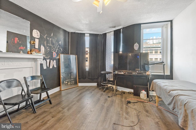 bedroom with hardwood / wood-style flooring and a textured ceiling