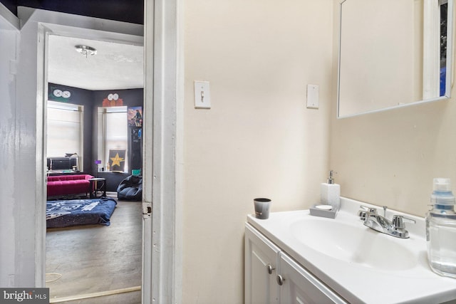 bathroom featuring a textured ceiling and vanity