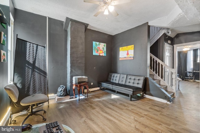 sitting room featuring a textured ceiling, hardwood / wood-style flooring, vaulted ceiling, and ceiling fan