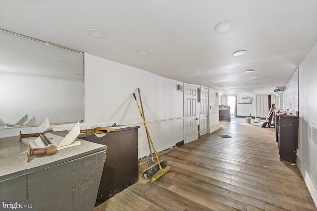 corridor featuring wood-type flooring and a wall mounted air conditioner