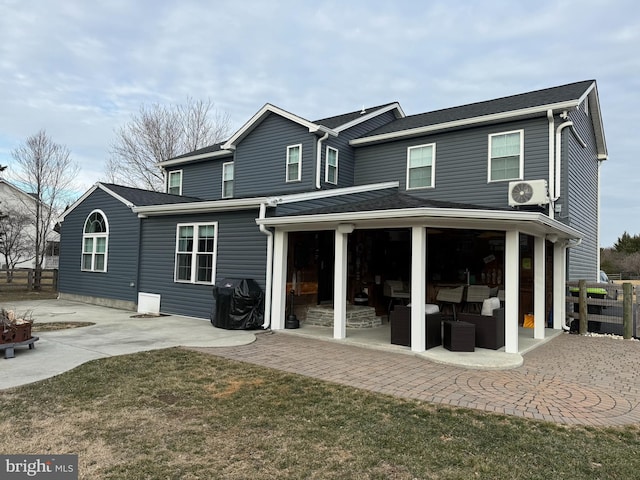 rear view of house with a patio area, roof with shingles, and ac unit