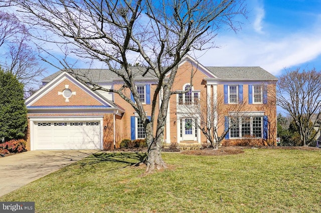 colonial inspired home with an attached garage, a front lawn, concrete driveway, and brick siding