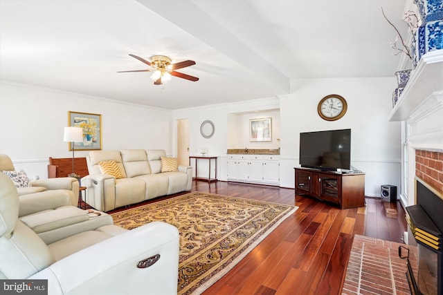 living room with dark wood-style floors, a fireplace, and a ceiling fan