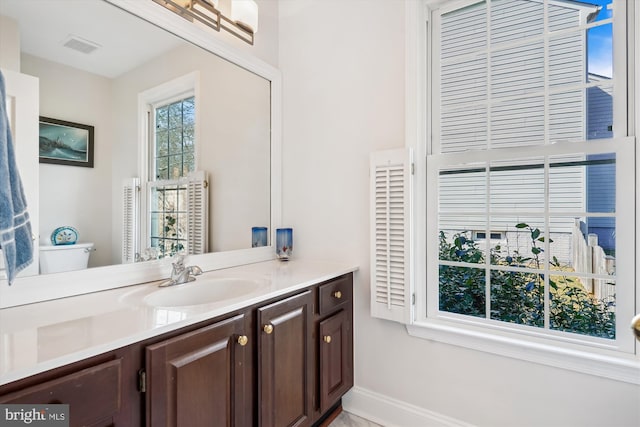 bathroom with visible vents, vanity, and baseboards