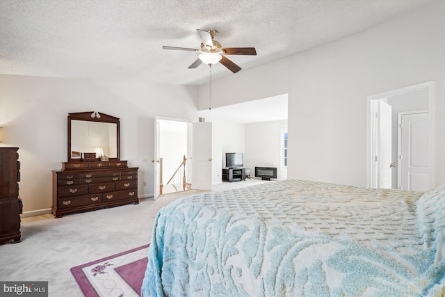 bedroom featuring carpet flooring, vaulted ceiling, a textured ceiling, and ceiling fan