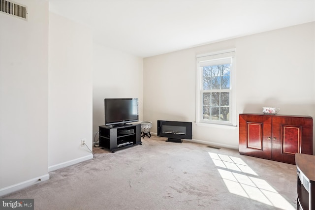 carpeted living room featuring visible vents and baseboards