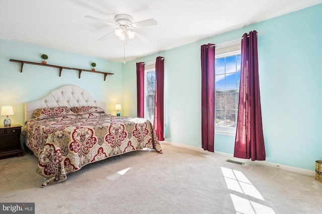 bedroom featuring ceiling fan, carpet, visible vents, and baseboards