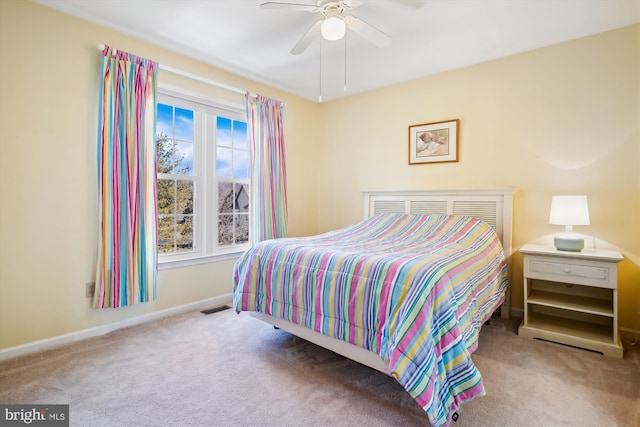 bedroom featuring a ceiling fan, carpet, visible vents, and baseboards