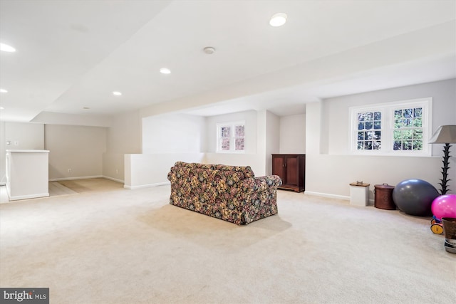 living area with light carpet, recessed lighting, and baseboards