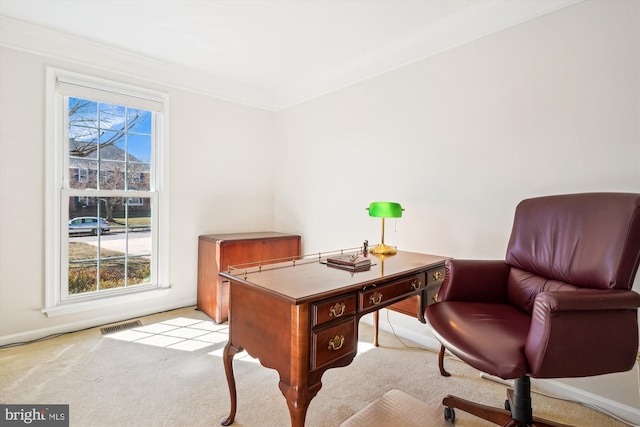 home office with crown molding, visible vents, light colored carpet, and a healthy amount of sunlight