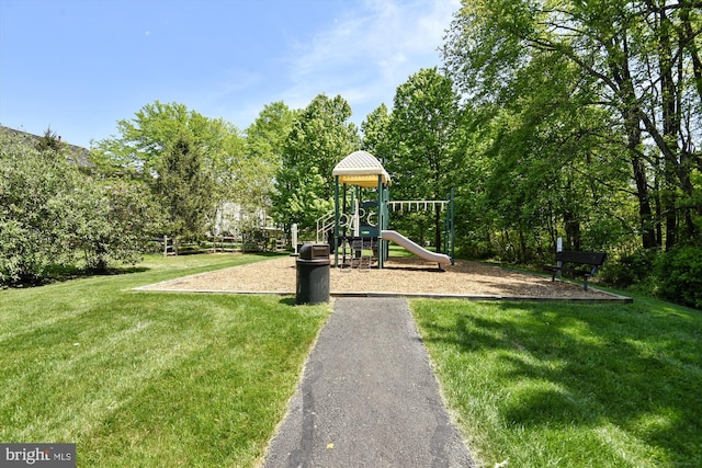 community jungle gym featuring a yard