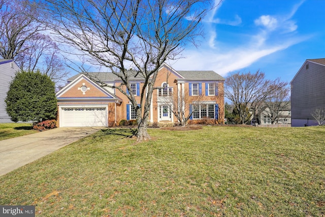 colonial inspired home with a garage, a front lawn, and concrete driveway