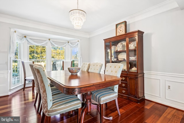 dining area with a chandelier, dark wood-style flooring, wainscoting, and ornamental molding