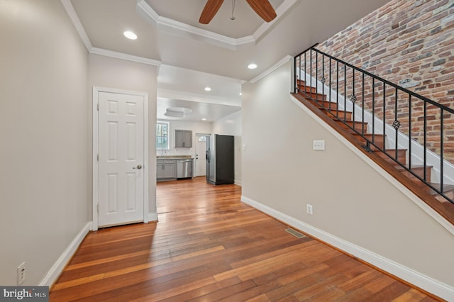 entrance foyer featuring hardwood / wood-style flooring, recessed lighting, visible vents, baseboards, and crown molding