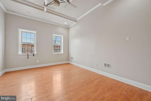 unfurnished room with light wood finished floors, baseboards, visible vents, and ornamental molding