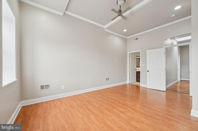 unfurnished room featuring light wood finished floors, ornamental molding, visible vents, and a ceiling fan