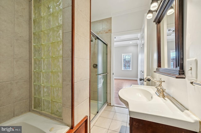 bathroom featuring a stall shower, tile patterned flooring, ornamental molding, and vanity