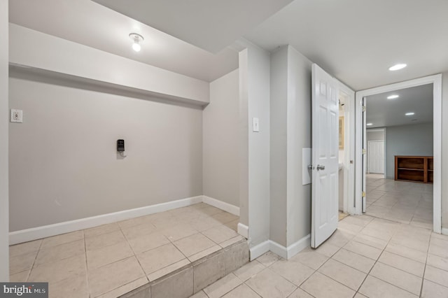 interior space featuring recessed lighting, baseboards, and light tile patterned flooring