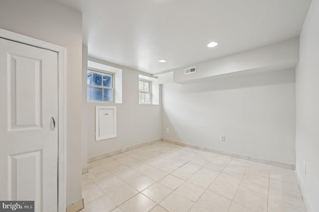 empty room featuring light tile patterned floors, baseboards, visible vents, and recessed lighting