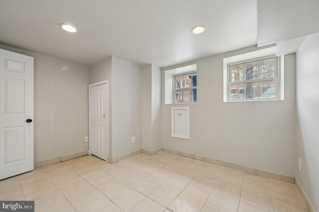 spare room featuring recessed lighting, baseboards, and light tile patterned flooring